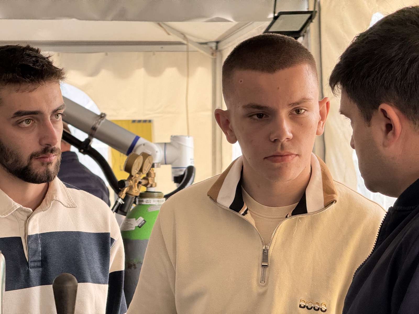 Attendees discussing Makweld Robotix technology at Octoberfest